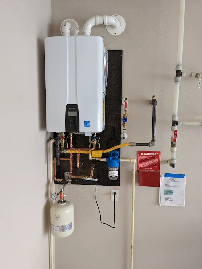 Professional plumber installing copper piping in a Barrett home